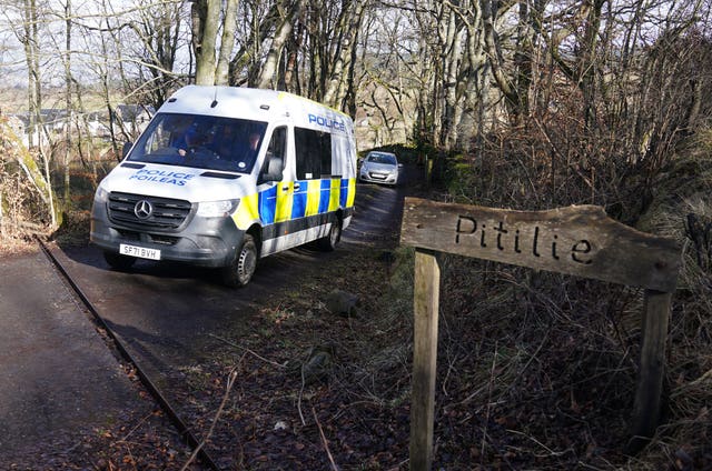 Police van on a rural track, next to a sign reading 'Pitilie'
