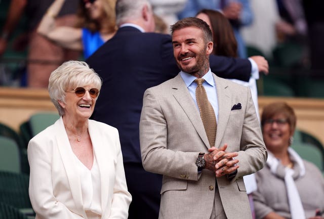 David Beckham stands in the Royal Box on Centre Court alongside his mum