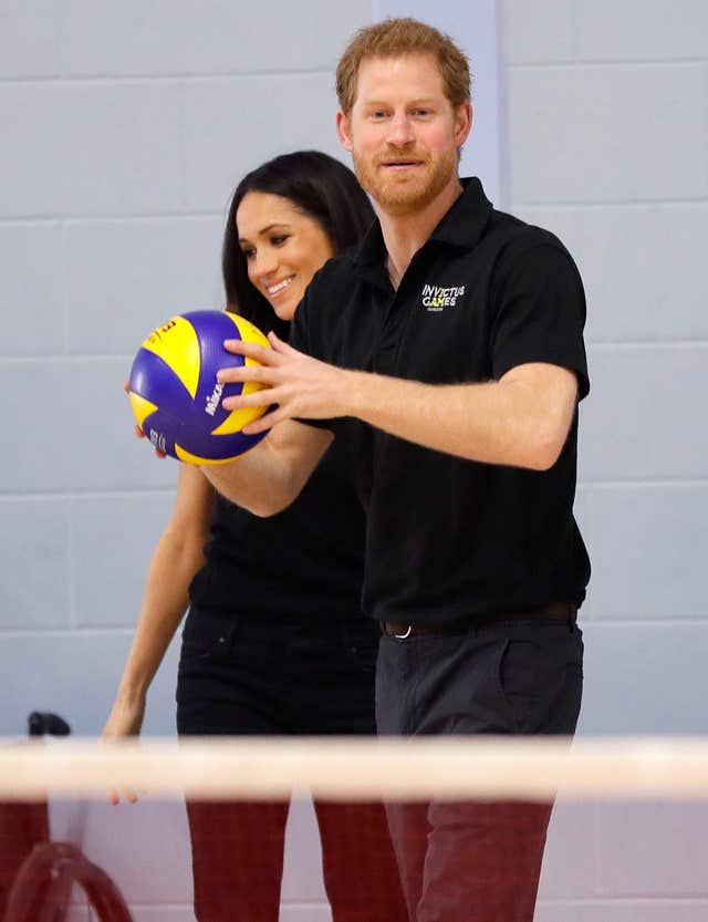 Prince Harry throws a volleyball as he and Meghan Markle meet athletes (Kirsty Wigglesworth/PA)