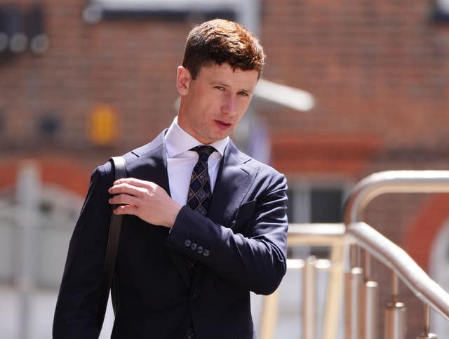 Oisin Murphy in suit and tie outside court