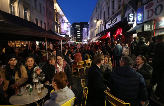 People sat at tables on pavements