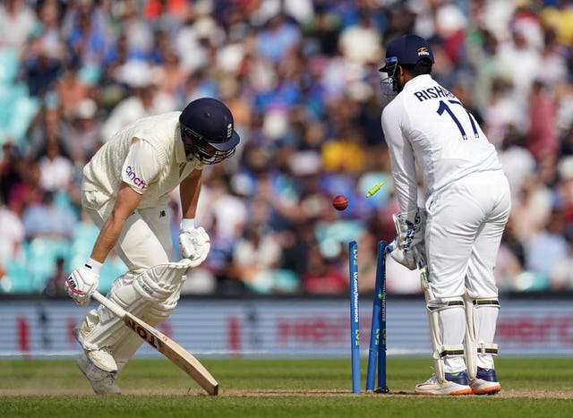 Dawid Malan, left, survives a run-out chance against India
