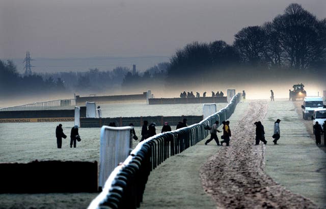 Ground staff out on the track in the fog and frost to prepare the track before a previous meeting at Haydock Park
