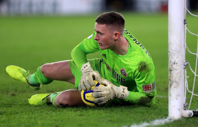 Dean Henderson makes a save against Manchester City