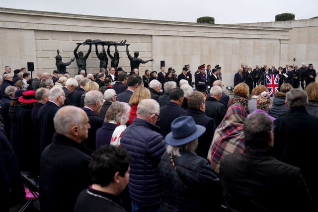 People observe a two-minute silence to remember the war dead on Armistice Day at the Armed Forces Memorial, at the National Memorial Arboretum, in Alrewas, Staffordshire