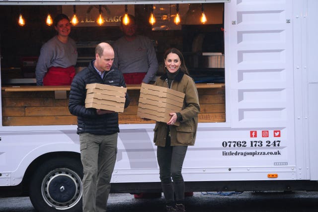 The Prince and Princess of Wales order 12 pizzas to say thank you to the mountain rescue team as they arrive for a visit to Dowlais Rugby Club near Merthyr Tydfil