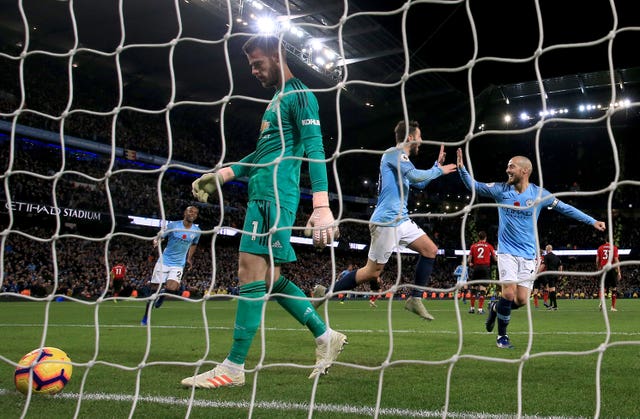 A dejected David De Gea turns to retrieve the ball after conceding a goal against Manchester City