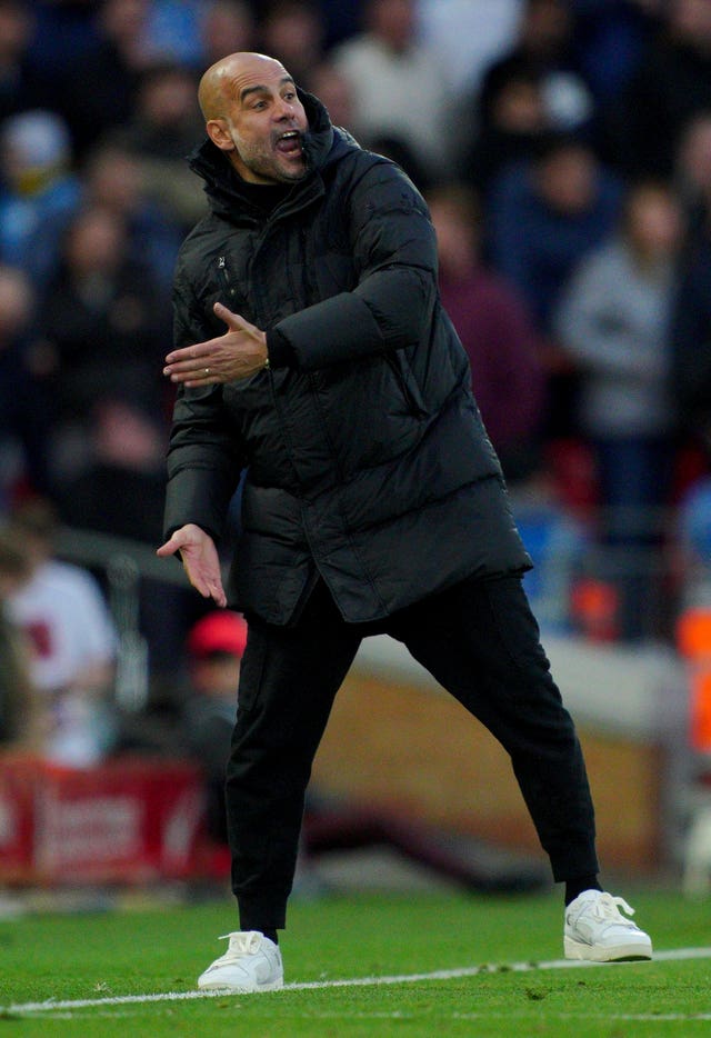 Pep Guardiola gestures on the touchline