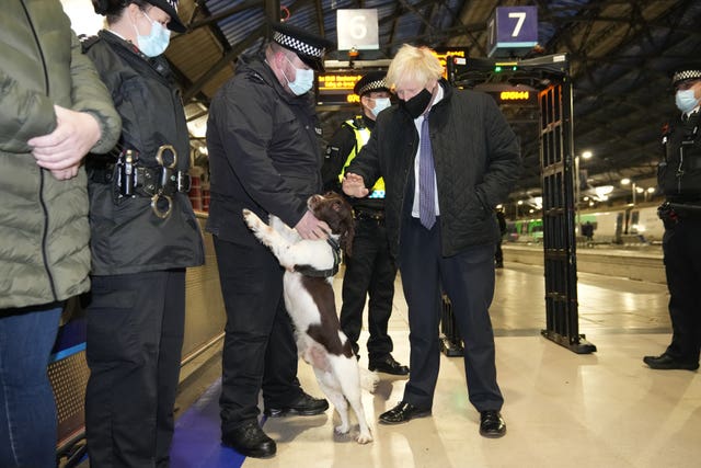 Boris Johnson talks to British Transport Police officers and police dog Ozzy at Liverpool Lime Street station