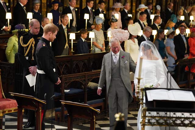 Meghan is accompanied to the altar by the Prince of Wales after her father Thomas Markle pulled out of attending her wedding