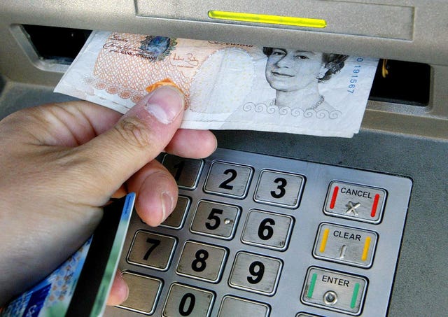 A person using a cash point (Gareth Fuller/PA)