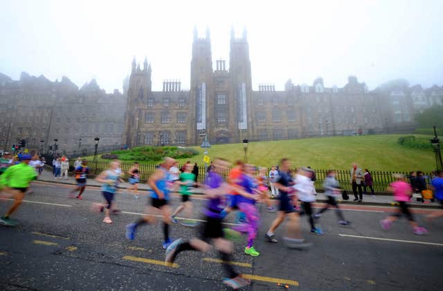 Fog coated the city centre buildings, proving ideal conditions for the Edinburgh marathoners (Jane Barlow/PA)