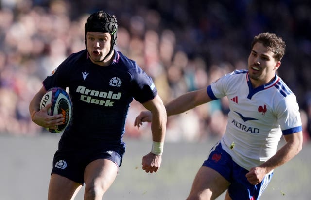 Darcy Graham, left, gets away from France’s Antoine Dupont 