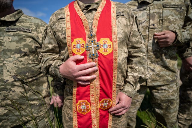 Ukrainian military chaplains wear religious clothes on the range