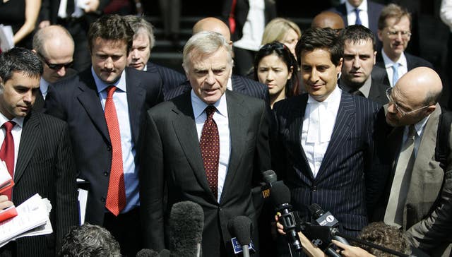 Max Mosley (centre) speaks to the press as he leaves the High Court in London after winning his case against the News of the World 