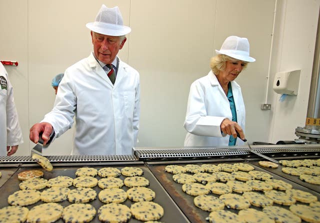 The King and Queen flipping Welsh cakes on hot plates