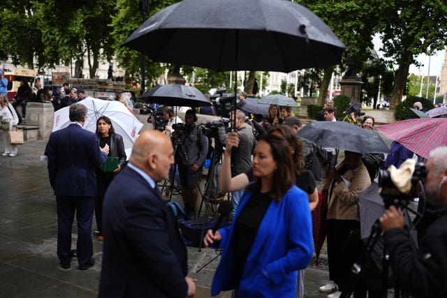 Members of the media report from outside the Supreme Court