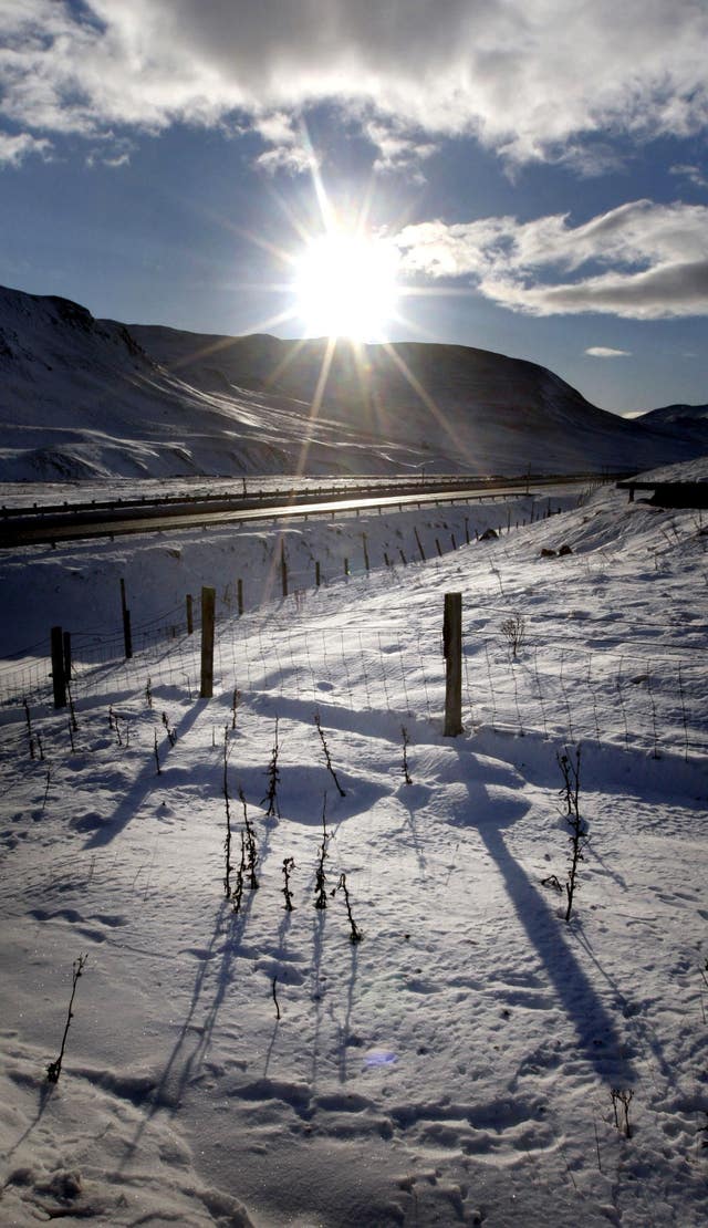 Snow-covered landscape with low winter sun