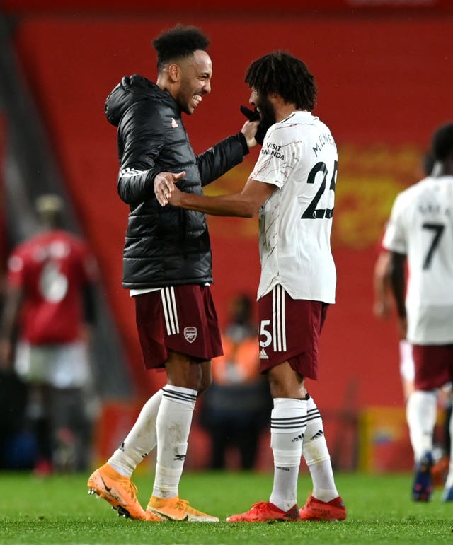 Mohamed Elneny celebrates with match-winner Pierre-Emerick Aubameyang (left) at Old Trafford