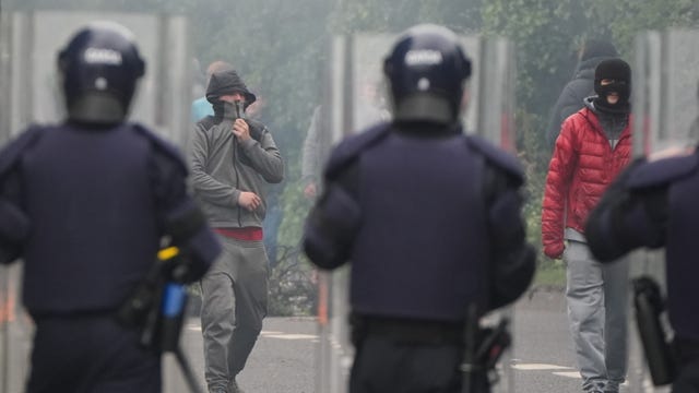 Gardai facing masked protesters