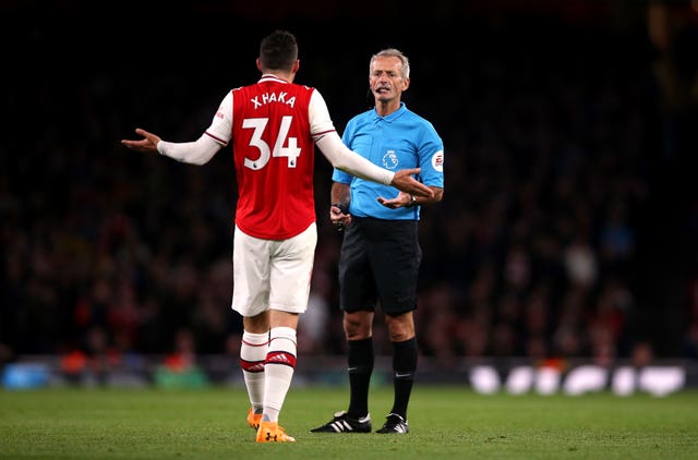 Granit Xhaka speaks to referee Martin Atkinson during the draw with Palace
