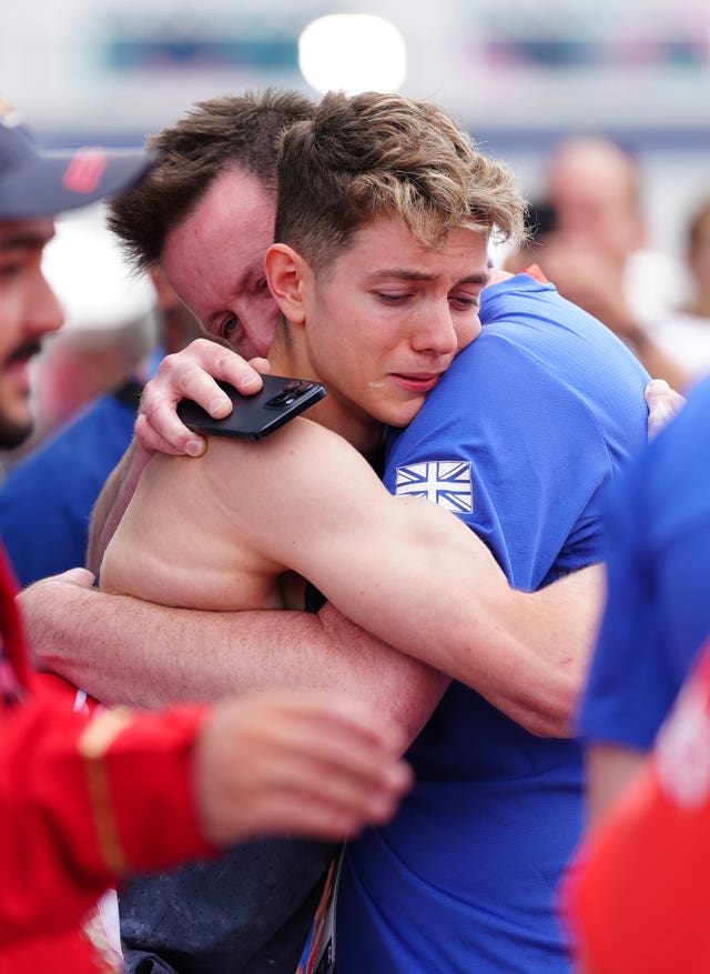 Toby Roberts hugging his father