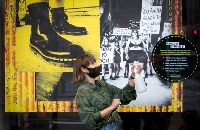 A member of staff at the Dr Martens shop in Edinburgh’s Princes Street (Jane Barlow/PA)