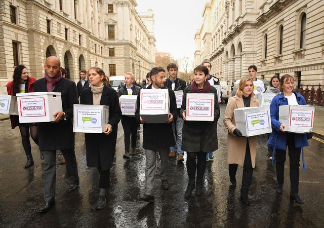 Chuka Umunna, front left, Caroline Lucas, third right, and Justine Greening, second right, with the petitions