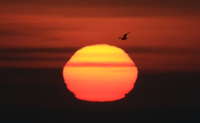 The sun rises over the North Sea near Whitley Bay, as a spell of warm weather this weekend is set to bring temperatures in parts of the UK close to records for February