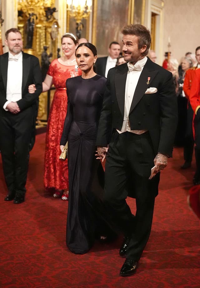 David and Victoria Beckham make their way along the East Gallery to attend the Qatari state banquet 