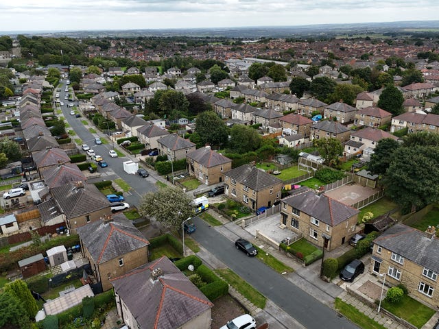 Emergency services in Westbury Road, Bradford, following a house fire where four people, including three children, died