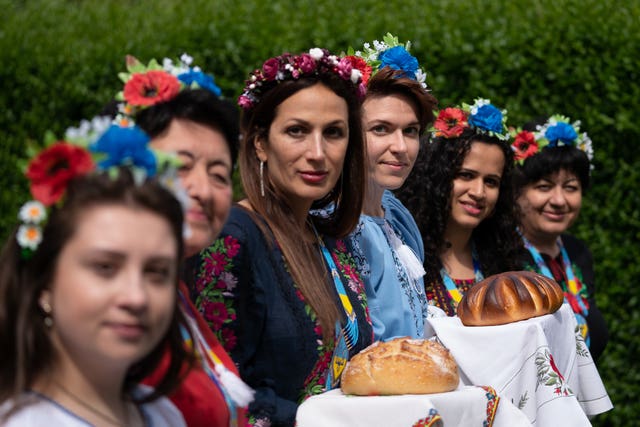 Kristina Korniiuk, 34, (third right) who fled the Ukraine following the Russian invasion, marks the Ukrainian celebration of Vyshyvanka Day at the home of her host Rend Platings in Cambridge (Joe Giddens/PA)