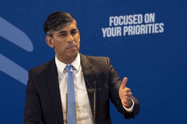 Rishi Sunak speaking in front of a Blue Conservative campaign backdrop with the slogan 'Focused on your priorities'