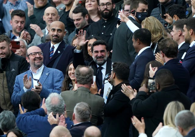 Yasir Al-Rumayyan, centre, waves to the Newcastle fans