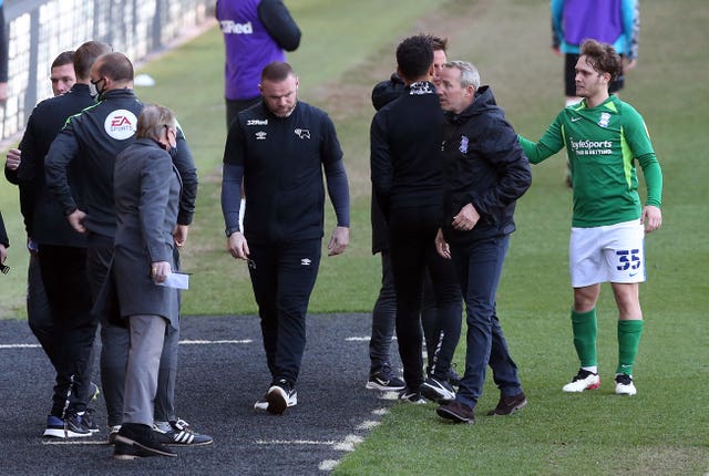 Derby manager Wayne Rooney (centre) and Birmingham counterpart Lee Bowyer after City's 2-1 win at Pride Park secured their Sky Bet Championship status and left the Rams in deep trouble