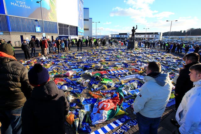 Fans view tributes to the Argentinian outside the Cardiff City Stadium ahead of the match (Mark Kerton/PA).