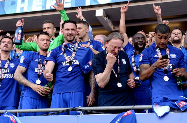 Warnock, third from right, celebrates with his Cardiff players after winning promotion to the Premier League in May