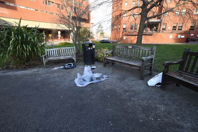 Hospital grounds where a pressure cooker and other bagged items are visible