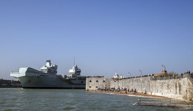 The Royal Navy aircraft carrier HMS Queen Elizabeth leaves Portsmouth Naval Base in Hampshire as it sets sail for exercises at sea 