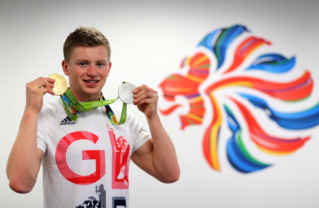 Adam Peaty poses with his medals