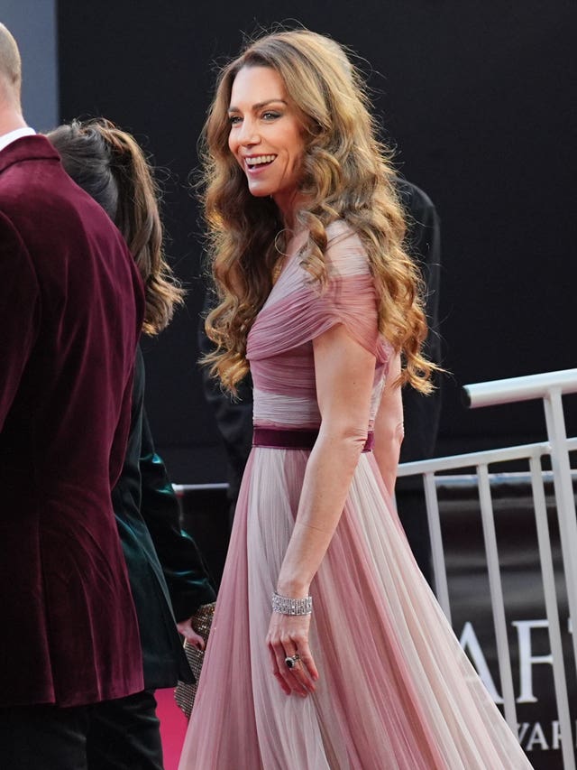 The Princess of Wales wore a long, flowing pale pink gown with accents that matched the Prince of Wales' burgundy velvet jacket