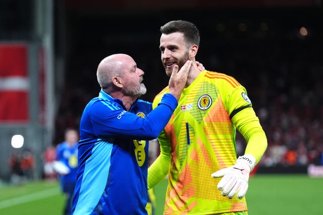 Scotland manager Steve Clarke congratulates goalkeeper Angus Gunn 