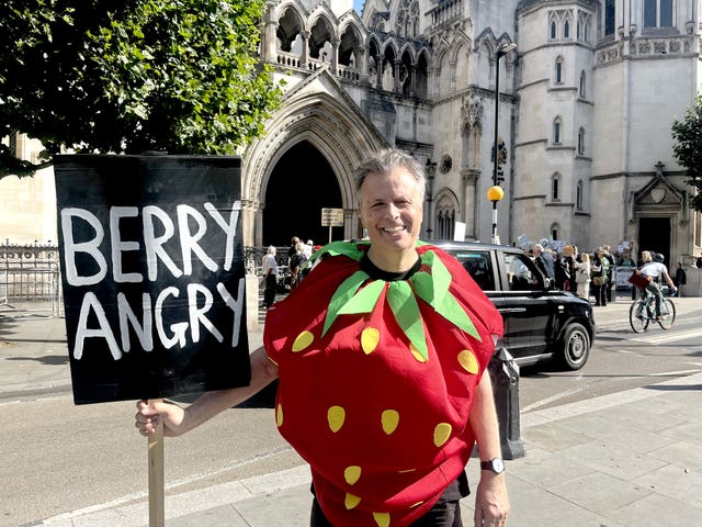 One of the protesters outside the Royal Courts of Justice last month (Callum Parke/PA)