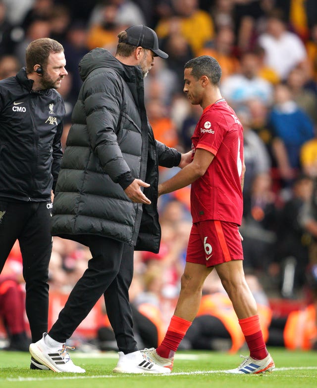 Liverpool manager Jurgen Klopp speaks to Thiago Alcantara as he leaves the pitch