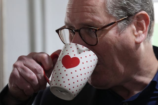Labour Party leader Sir Keir Starmer has a drink from a mug with a red love heart on it