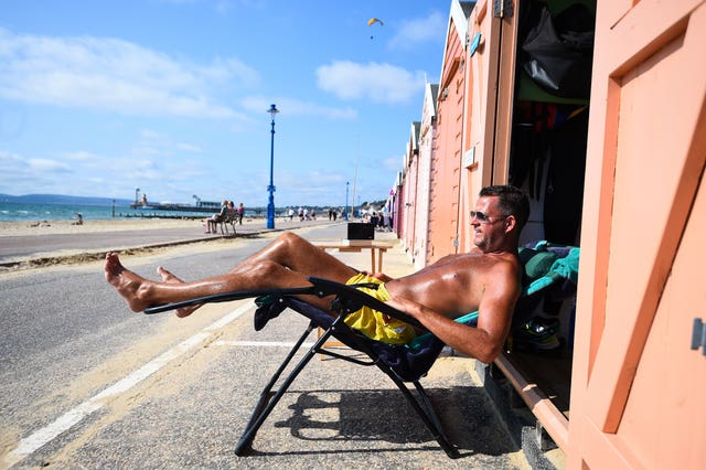 Stuart Henderson enjoys the Autumn sunshine from his beach hut in Bournemouth 