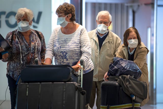 Passengers walk through arrivals in Terminal 2 at Heathrow Airport (Victoria Jones/PA)