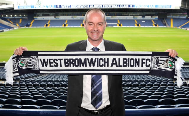 Steve Clarke holds up a West Brom scarf