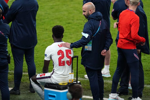 England's Bukayo Saka sits down after missing his penalty