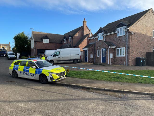 Police at the scene in The Row in Sutton, near Ely, Cambridgeshire, where police found the body of a 57-year-old man who had died from gunshot wounds